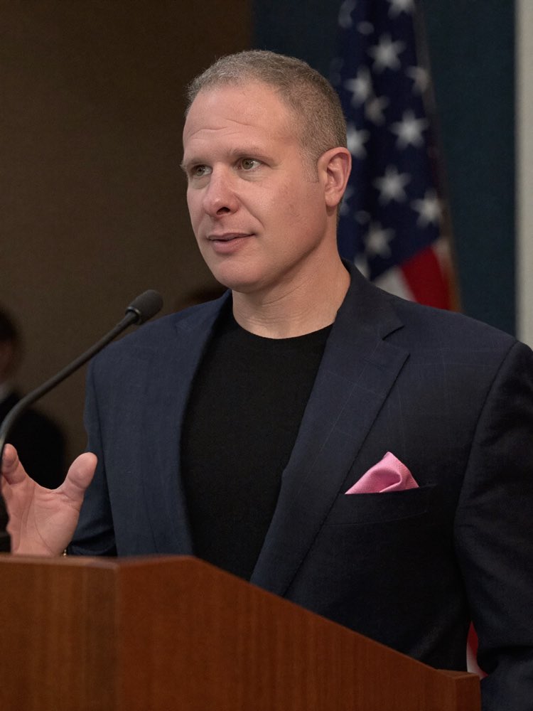 Josh speaking at a podium